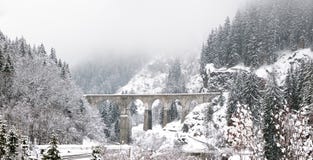 An old iconic Viaduct Bridge spans a snowy winter river stock images An old iconic Viaduct Bridge spans a snowy winter river stock images
