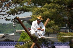 Old korean man performes on the tightrope