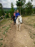 Old Lady Riding a Horse With Grandkids in Colorado