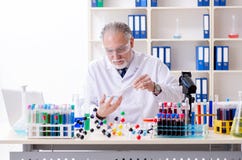 Old male chemist working in the lab stock photos Old male chemist working in the lab stock photos