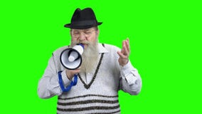 Old man speaking with megaphone on green screen.
