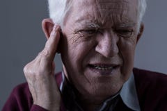 Old man with tinnitus Stock Image Old man with tinnitus Stock Image