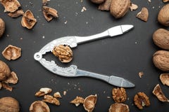 Old metal hazel for cracking nuts with a nut kernel on a black background, top view royalty free stock photos Old metal hazel for cracking nuts with a nut kernel on a black background, top view royalty free stock photos