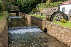 Old mill with a stream enclosed in a stone channel with brickwork royalty free stock image Old mill with a stream enclosed in a stone channel with brickwork royalty free stock image
