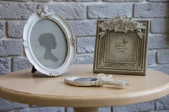 Old picture frames, lying mirror on the table with grey brick wall background, closeup Royalty Free Stock Images Old picture frames, lying mirror on the table with grey brick wall background, closeup Royalty Free Stock Images