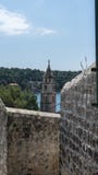 Old town bell tower sea view. Cavtat small coast village. Summer area with narrow stone streets and forest. Croatia resort stock images Old town bell tower sea view. Cavtat small coast village. Summer area with narrow stone streets and forest. Croatia resort stock images