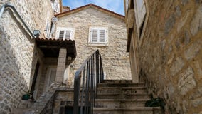 Old town, stone building in the narrow streets. The tiny staircase leads to the old house. The courtyard of one of the houses in royalty free stock photography Old town, stone building in the narrow streets. The tiny staircase leads to the old house. The courtyard of one of the houses in royalty free stock photography