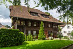 Old two-story wooden dwelling house with an attic and a tiled roof in Lucerne, Switzerland stock photography Old two-story wooden dwelling house with an attic and a tiled roof in Lucerne, Switzerland stock photography
