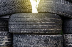 Old used car tires stacked in stacks