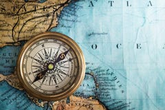 Old vintage retro compass on ancient map background. Travel geog