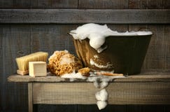 Old wash tub with soap on bench. Old wash tub with soap on rustic bench Old wash tub with soap on bench. Old wash tub with soap on rustic bench