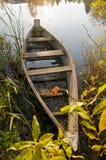 Old wooden boat locked at lake. Morning scene. stock photo Old wooden boat locked at lake. Morning scene. stock photo