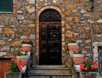 Old wooden door decorated with flowerpots and steps in medieval royalty free stock photos Old wooden door decorated with flowerpots and steps in medieval royalty free stock photos