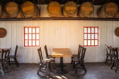 Old wooden table and chairs locate in restaurant with wooden wine barrel interior in restaurant. royalty free stock image Old wooden table and chairs locate in restaurant with wooden wine barrel interior in restaurant. royalty free stock image