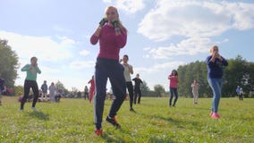 Female boxing in a park on background blue sky, healthy lifestyle stock video footage Female boxing in a park on background blue sky, healthy lifestyle stock video footage