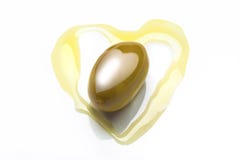 Olive in heart shaped olive oil