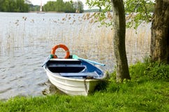 One boat on lake with life buoy Stock Image One boat on lake with life buoy Stock Image