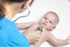 One caucasian female doctor is listening heartbeat of infant boy by stethoscope Stock Photo One caucasian female doctor is listening heartbeat of infant boy by stethoscope Stock Photo