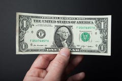 One dollar close-up in hand on a black background royalty free stock photos One dollar close-up in hand on a black background royalty free stock photos