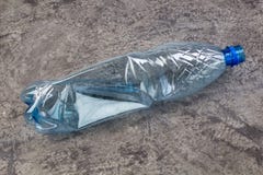 One empty used plastic bottles on bitonny, gray background. stock image One empty used plastic bottles on bitonny, gray background. stock image