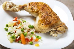 One fried chicken leg with boiled vegetables like rice, green pe Stock Photo One fried chicken leg with boiled vegetables like rice, green pe Stock Photo