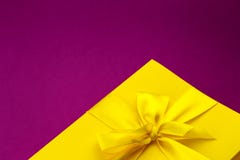 Bright yellow giftbox on dark pink background royalty free stock images Bright yellow giftbox on dark pink background royalty free stock images