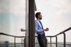 One male worker drinking coffee on office balcony royalty free stock image One male worker drinking coffee on office balcony royalty free stock image