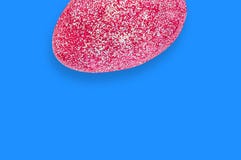 One red artificial eggs with sparkles on blue table. Copy space for your text. View from above. Happy Easter celebration stock photography One red artificial eggs with sparkles on blue table. Copy space for your text. View from above. Happy Easter celebration stock photography