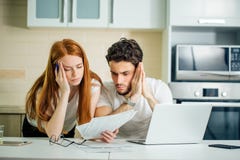 Ongerust gemaakt paar die hun rekeningen online met laptop thuis in woonkamer betalen stock foto Ongerust gemaakt paar die hun rekeningen online met laptop thuis in woonkamer betalen stock foto