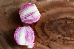 Onion cut macro close up in wooden background with copy space stock photos Onion cut macro close up in wooden background with copy space stock photos