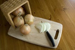 Onions In A Basket On A Cutting Board. Royalty Free Stock Photography