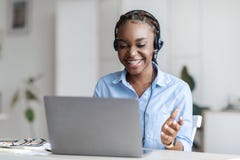 Online Tutoring. Black Female Tutor In Headset Having Video Conference With Laptop Royalty Free Stock Photo