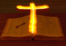 The open Holy Bible is on the table. Ancient key. The Holy Cross glows over the Bible and illuminates its pages. Burning Cross.