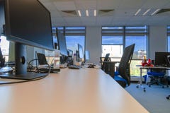 Open Space Empty Modern Office Interior. Empty Office Desks And Turned Off Computers And Monitors Against Sunlight From Windows. Stock Photography Open Space Empty Modern Office Interior. Empty Office Desks And Turned Off Computers And Monitors Against Sunlight From Windows. Stock Photography