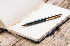 Opened blank notebook with elegant fountain pen Stock Photo Opened blank notebook with elegant fountain pen Stock Photo
