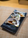 Opened fresh oysters on black plate royalty free stock photography Opened fresh oysters on black plate royalty free stock photography