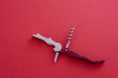 Opened Sommelier`s Knife With Corkscrew And Bottle Opener, Waiter`s Knife Professional, On Red Background Stock Images Opened Sommelier`s Knife With Corkscrew And Bottle Opener, Waiter`s Knife Professional, On Red Background Stock Images