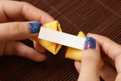Opening A Fortune Cookie stock image Opening A Fortune Cookie stock image