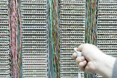 Operator installing telephone switchboard with cables Stock Photo Operator installing telephone switchboard with cables Stock Photo