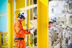 Operator recording operation of oil and gas process at oil and rig plant, offshore oil and gas industry, offshore oil and rig Royalty Free Stock Image Operator recording operation of oil and gas process at oil and rig plant, offshore oil and gas industry, offshore oil and rig Royalty Free Stock Image