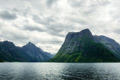Opinión dramática de la tarde del fiordo de Hjorundfjorden imagen de archivo libre de regalías Opinión dramática de la tarde del fiordo de Hjorundfjorden imagen de archivo libre de regalías