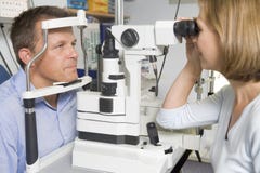 Optometrist in exam room with man