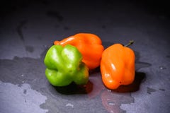 Bright colourful green and orange habanero hot peppers on table Royalty Free Stock Photo Bright colourful green and orange habanero hot peppers on table Royalty Free Stock Photo