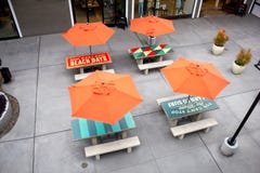 Orange paraplytabeller på den Stillahavs- staden royaltyfri foto Orange paraplytabeller på den Stillahavs- staden royaltyfri foto
