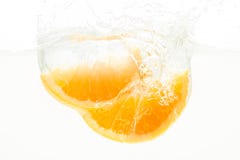 Orange Slices falling deeply under water with a big splash Royalty Free Stock Photo Orange Slices falling deeply under water with a big splash Royalty Free Stock Photo