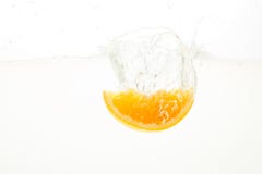 Orange Slices falling deeply under water with a big splash Stock Photos Orange Slices falling deeply under water with a big splash Stock Photos