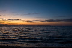 Orange Sunset Above Dark Water of Sea. Twilight on the Sea Coast Stock Images Orange Sunset Above Dark Water of Sea. Twilight on the Sea Coast Stock Images