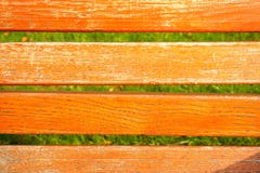 Orange wooden texture and green grass background. In the image, it is an Orange wooden texture and green grass background Royalty Free Stock Photography Orange wooden texture and green grass background. In the image, it is an Orange wooden texture and green grass background Royalty Free Stock Photography