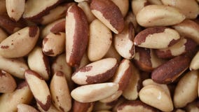 Organic bazil nut texture on rotating background. Food ingredient background. Vegan, vegetarian diet. Healthy lifestyle