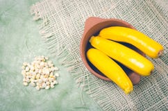 Organic and delicious zucchinis displayed in. Ceramic terracota bowl with some cut sweet white corn on hemp a cloth royalty free stock photos Organic and delicious zucchinis displayed in. Ceramic terracota bowl with some cut sweet white corn on hemp a cloth royalty free stock photos